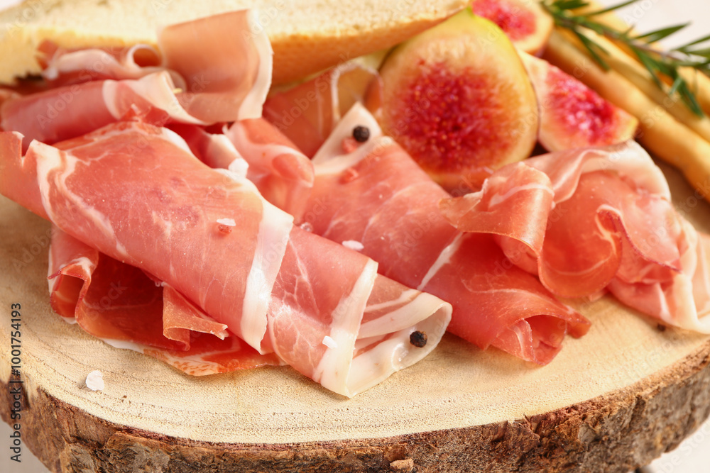 Wooden board with slices of tasty prosciutto, closeup Wooden board with slices of tasty prosciutto, closeup