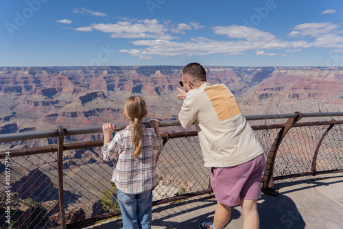 Father and daughter are standing at the Mother Point of Grand Canyon. Arizona National Park, USA.  photo