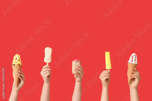 Female hands with different sweet ice-cream on red background