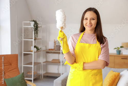 Young housewife with pp-duster at home