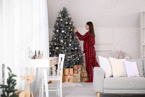 Happy young woman in pajama...
