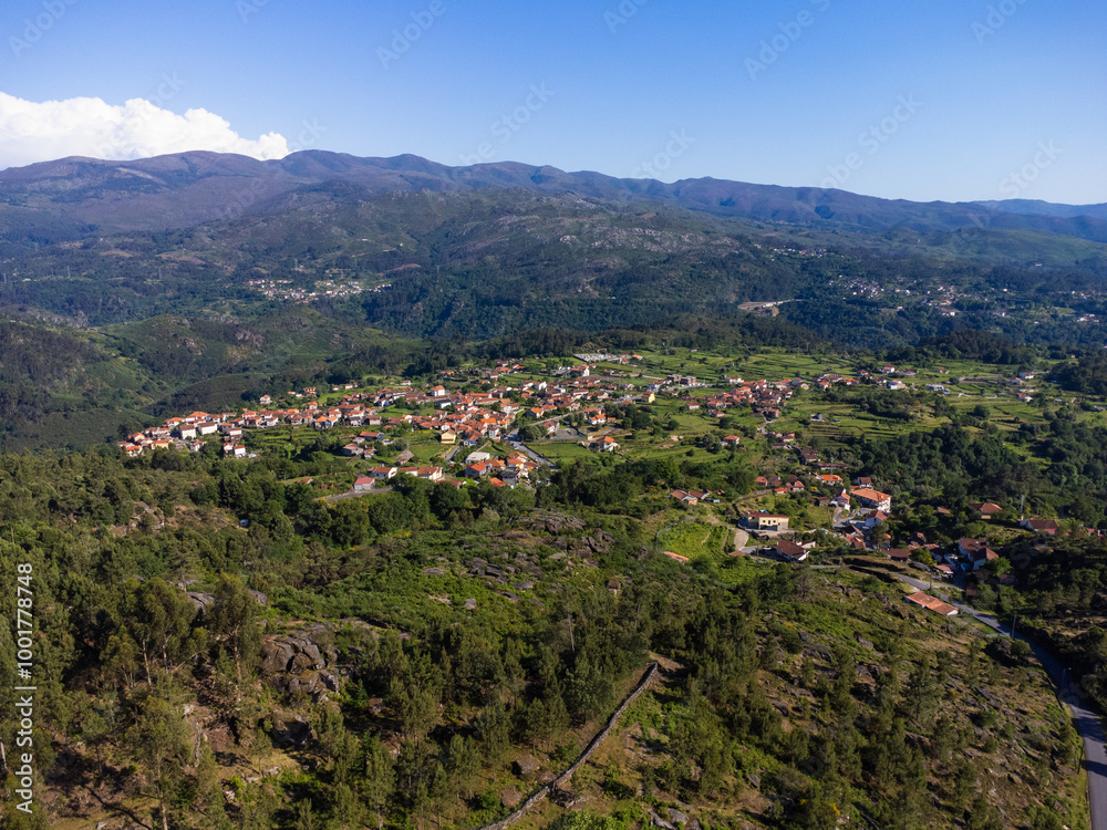 Obraz premium Beautiful and scenic aerial view of village of Gerês, Soajo, Portugal. Spring day. City, houses, mountains and waterfalls. Near Porto. Drone.