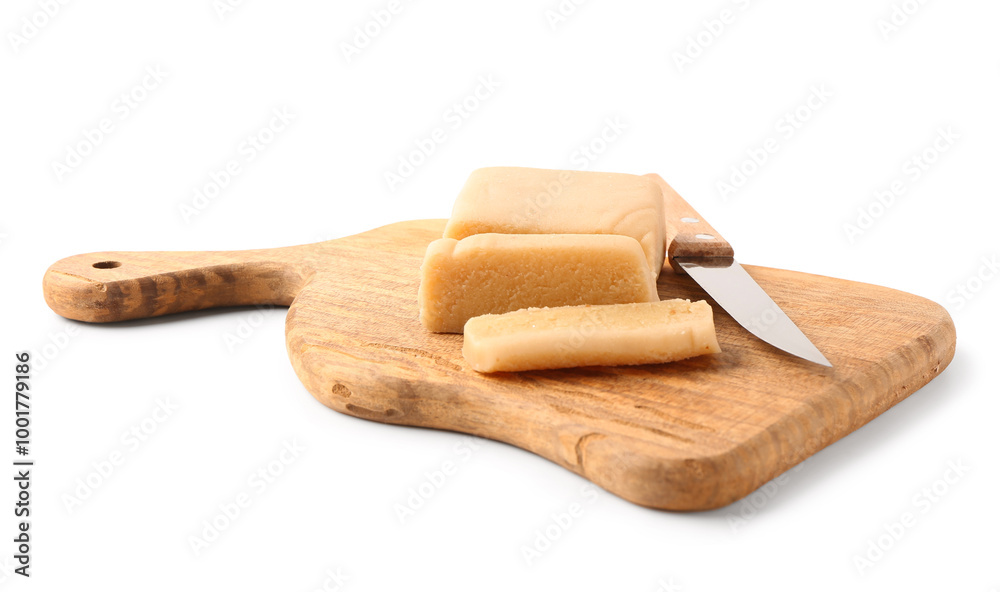 Wooden cutting board with marzipan bar and knife on white background Wooden cutting board with marzipan bar and knife on white background