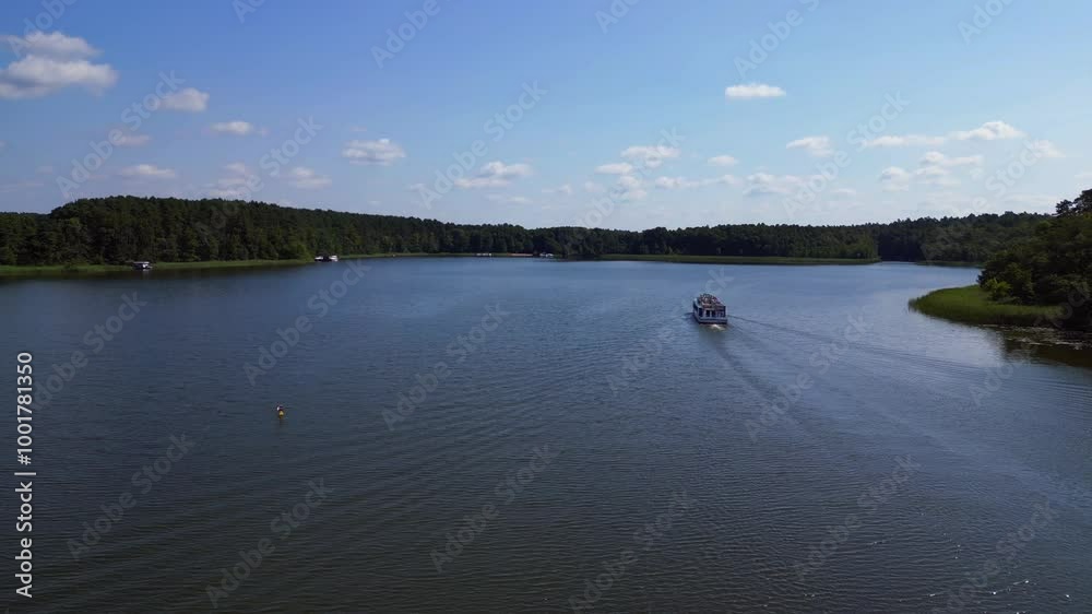 Passenger ferry boat on lake, green forest. Lovely aerial view flight drone