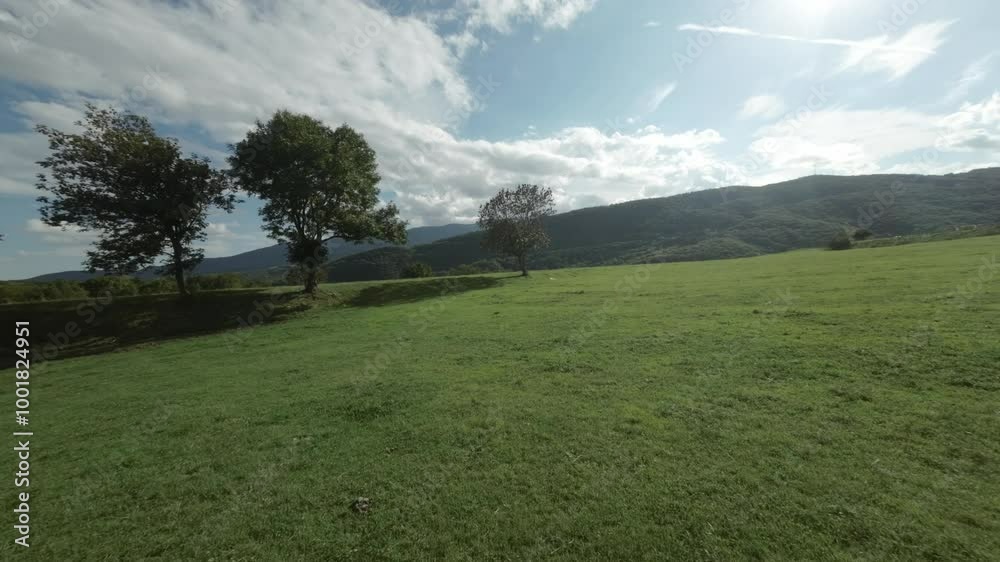 A Serene and Beautiful Green Landscape Set Under A Softly Cloudy Sky Awaiting Exploration A Serene and Beautiful Green Landscape Set Under A Softly Cloudy Sky Awaiting Exploration