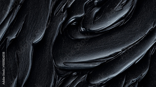 a close-up, top-down view, texture background of black sesame paste spread across the frame, filling the image with its deep, almost black color and smooth, creamy texture photo