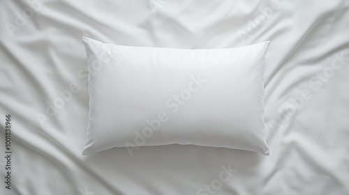 good sleep and morning concept: top-down view of a soft, rectangular white pillow on smooth white sheets