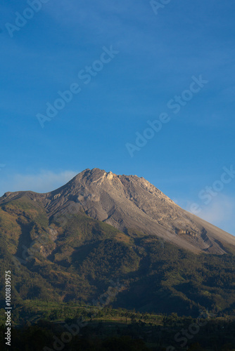 Portrait view of The great Mount Merapi Volcano with clear blue sky in the background viewed from Selo Boyolali, Central Java - Indonesia.