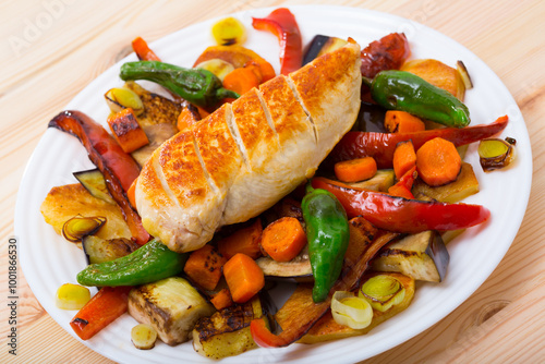 Traditional Bulgarian Plakiya with grilled chicken fillet served on white plate photo