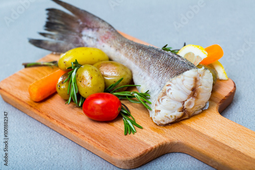 Hake baked by rustically style. Hake 250 gramm (it is better to take the tail), rub it with salt and pepper, bake in the oven for 20 minutes at 220 gramm Served with potatoes and fresh vegetables