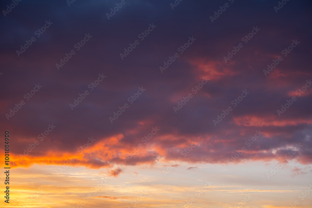 Vibrant sunset sky with dramatic clouds over calm horizon. Vibrant sunset sky with dramatic clouds over calm horizon.