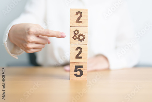 2024 year change to 2025 year block with gear icon. Business Process, Team, teamwork, Goal, Target, Resolution, strategy, plan, Action, motivation, change, brainstorm and New Year start concepts