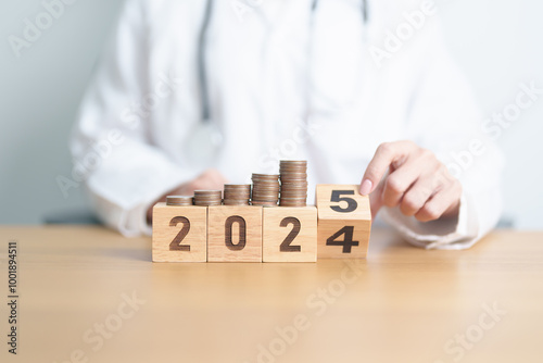 2024 end year to Happy New Year 2025 with Doctor and coins stack. Money stack Counting arrangement for deposit, Healthcare cost, Money Saving, Health Insurance, Medical, Donation and Financial concept