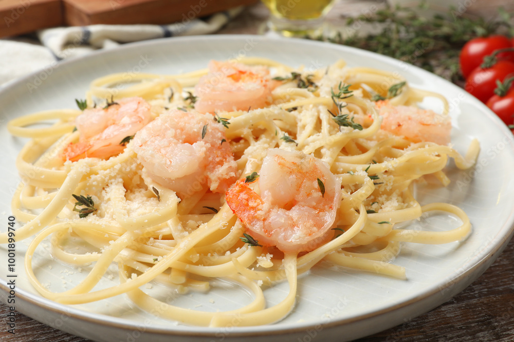 Delicious pasta with shrimps on wooden table, closeup