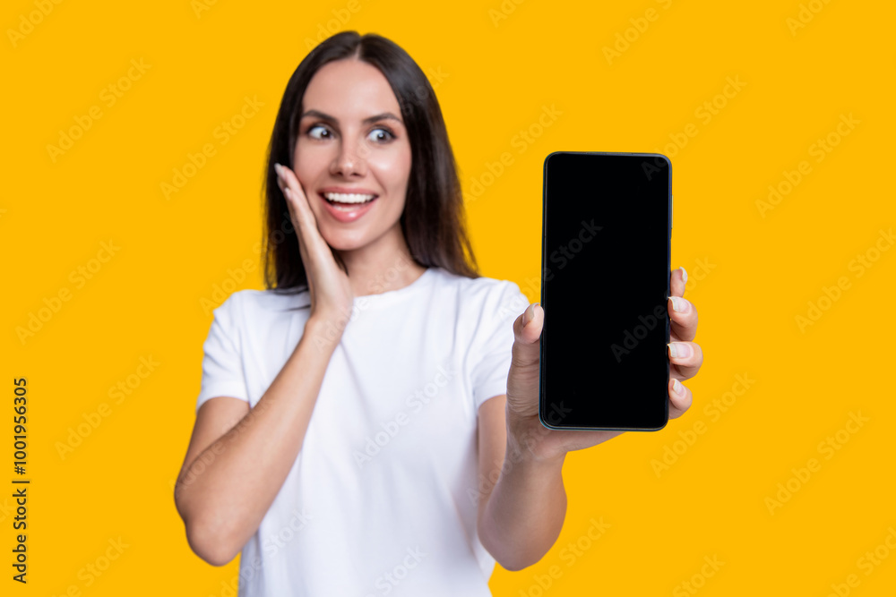Presenting product. Advertisement of business app. Woman presenting phone screen. Young girl showing phone screen isolated on yellow. Millennial woman. New phone app. Girl offer advertisement Presenting product. Advertisement of business app. Woman presenting phone screen. Young girl showing phone screen isolated on yellow. Millennial woman. New phone app. Girl offer advertisement