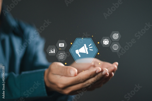 Advertising concept, PR Public relations, Businessman holding advertising icons, plan advertising marketing strategies to target social media native, ad, advertisers, sales. photo