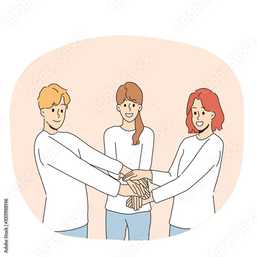 Friendly team of people holding hands demonstrate cohesion and unity, wanting to achieve goals together. Team of young guy and two girls carrying out volunteer or charitable activities
