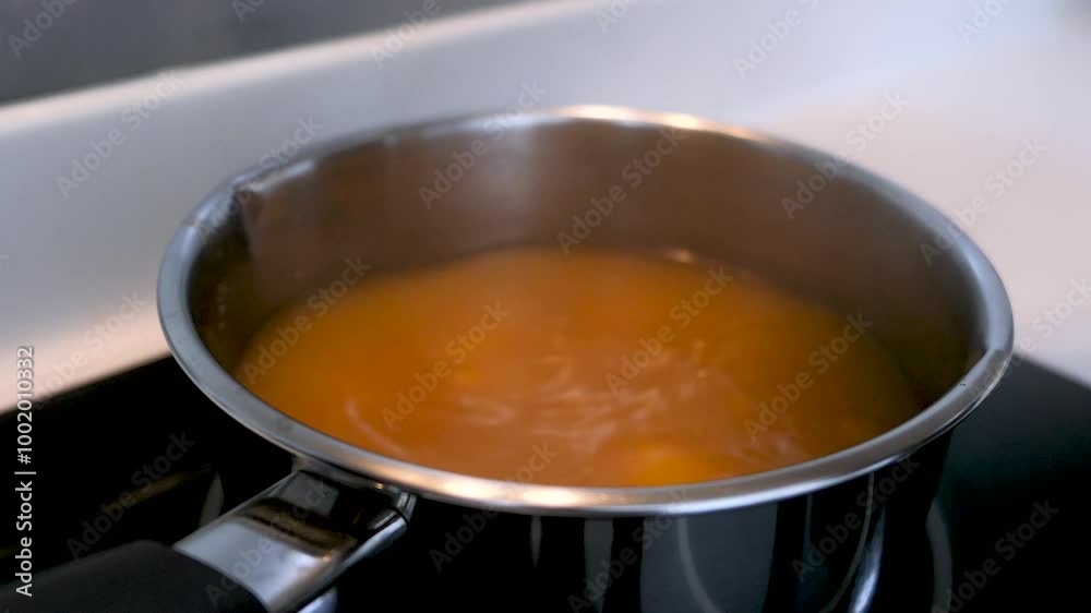 Using Spoon To Push Tofu Into Hot Boiling Miso Soup In Cooking Pot Using Spoon To Push Tofu Into Hot Boiling Miso Soup In Cooking Pot