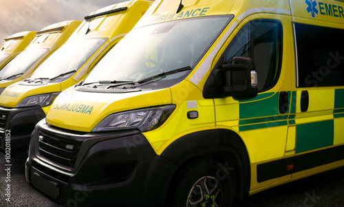 Ambulances - emergency services ambulance vehicles on standby.  The medically equipped transport moves patients with paramedics to a local health care facility depot, such as a hospital for treatment photo