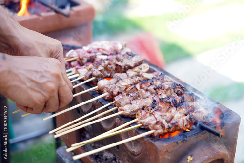 Grilling Sate Klathak, a typical Yogyakarta satay dish made from young goat meat (lamb) without using soy sauce but only with salt, pepper and onions, as well as curry sauce
 photo