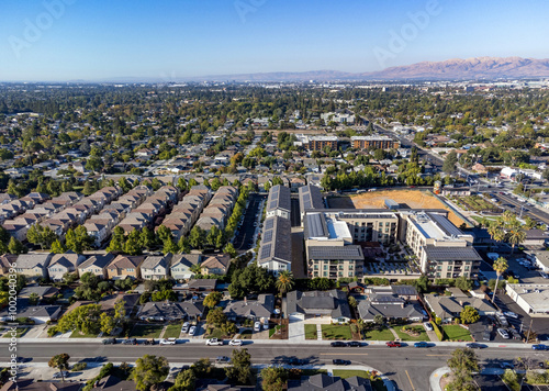 Aerial view of a suburban neighborhood in Silicon Valley with a mix of single family residential homes, townhouses and modern apartment buildings
