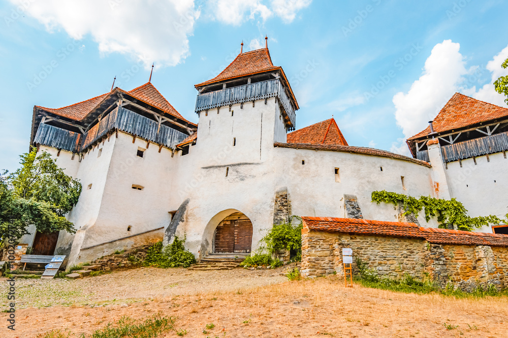 Viscri, Romania. Blue old painted traditional house from village, Transylvania. The Viscri fortified church
