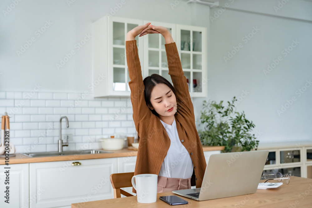 Office syndrome concept. Young asian woman feeling pain in neck and shoulder after working on computer laptop for a long time. She stretches to relax her muscles Office syndrome concept. Young asian woman feeling pain in neck and shoulder after working on computer laptop for a long time. She stretches to relax her muscles