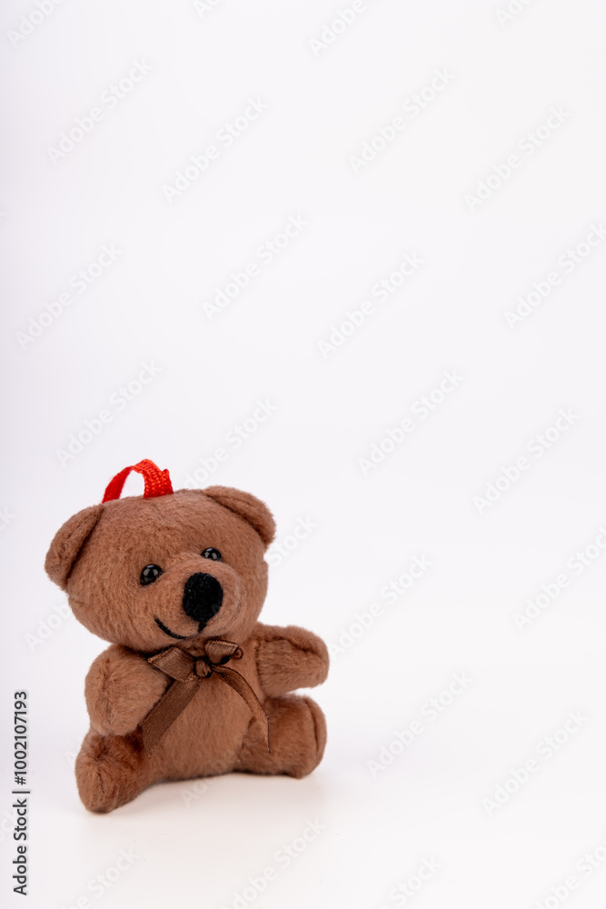 Festive teddy bear ornament with Santa hat on a white background Festive teddy bear ornament with Santa hat on a white background