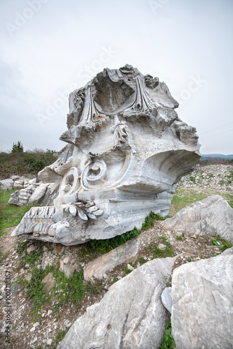 Kyzikos Ancient City is located in Erdek district. A girl watching the world's biggest Corinthian-style column head was unearthed.  
 photo