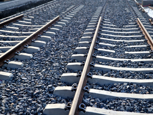 new and precise laying of tracks using leveling devices at the fork in two tram tracks. a layer of gravel above which concrete sleepers are placed. rubber anti-vibration base made of rubber photo