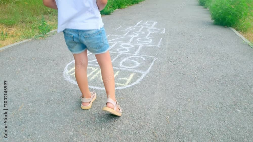 Cute adorable little young child girl playing hopscotch outdoor. Funny activity game for kids on playground outside. Summer backyard street sport for children. Happy childhood lifestyle. Cute adorable little young child girl playing hopscotch outdoor. Funny activity game for kids on playground outside. Summer backyard street sport for children. Happy childhood lifestyle.