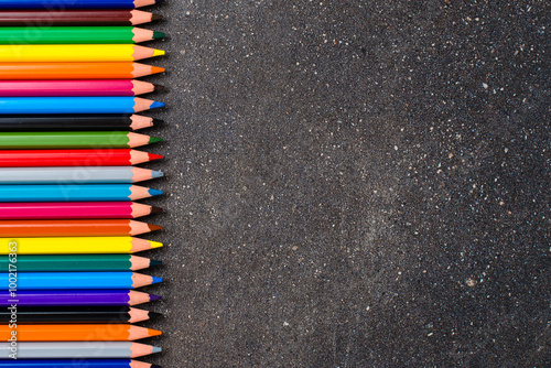 Colorful pencils on dark table
