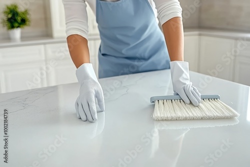 Woman in Apron Cleaning Countertop Surface