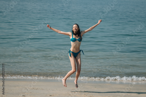 Woman jumping on beach free and happy