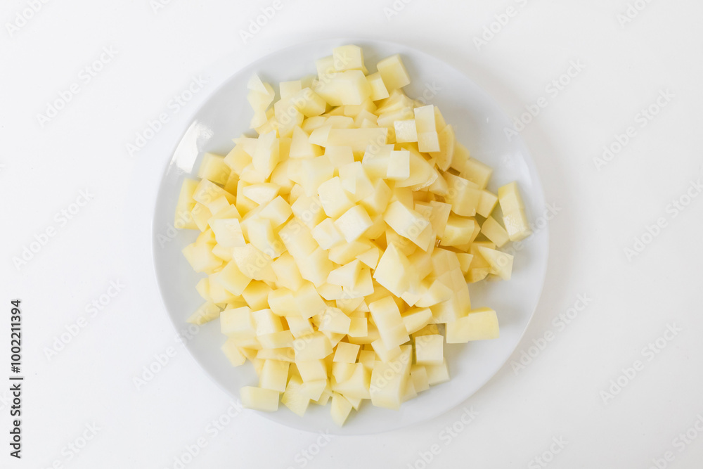 Chopped potatoes on a white plate, ideal for cooking healthy meals and Thanksgiving side dishes Chopped potatoes on a white plate, ideal for cooking healthy meals and Thanksgiving side dishes