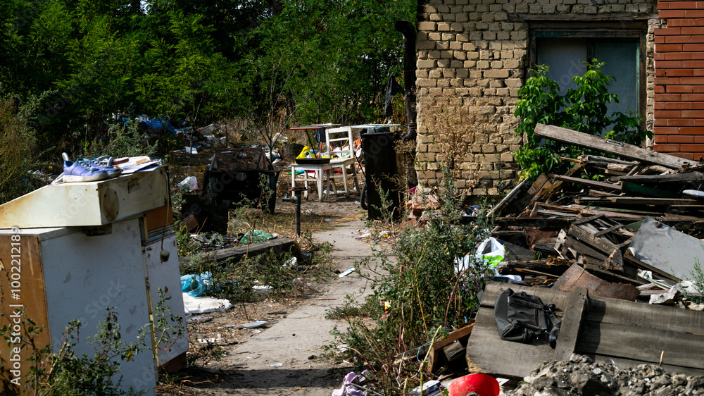 Αυτοκόλλητο A cluttered backyard with neglected furniture and scattered debris highlights se