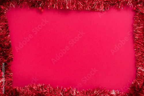 Bright red Christmas ornament on a red textured background