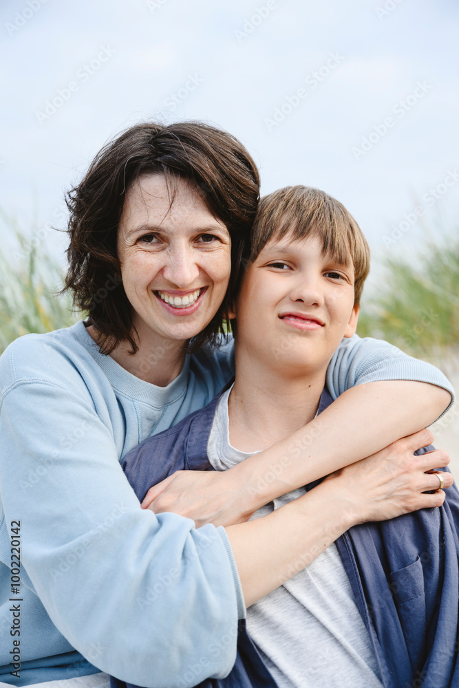 Happy mother embracing son at beach Happy mother embracing son at beach