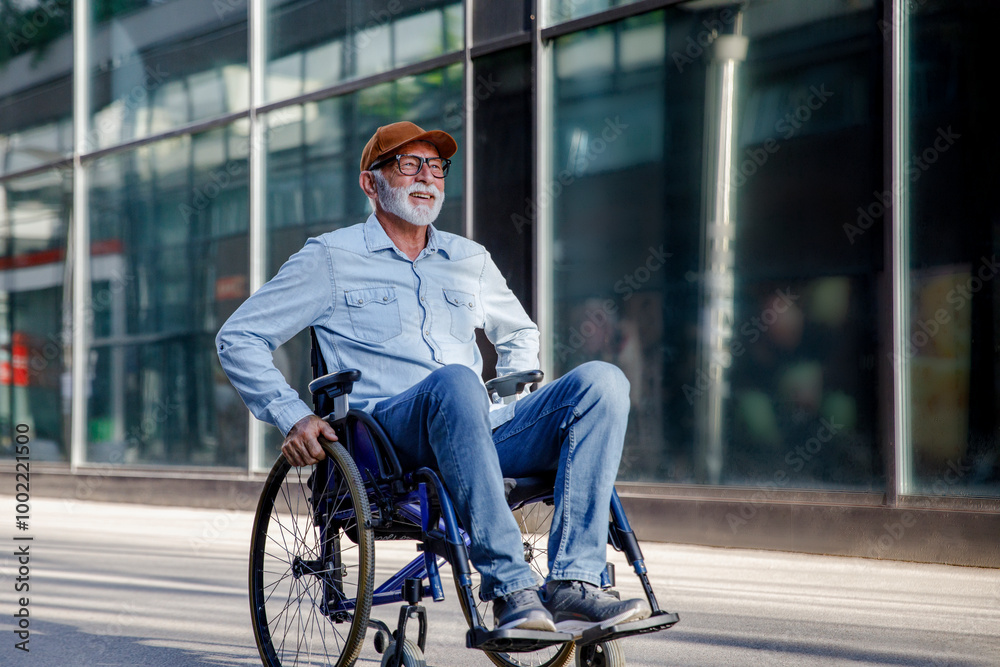 Smiling retired senior man sitting in wheelchair on footpath Smiling retired senior man sitting in wheelchair on footpath