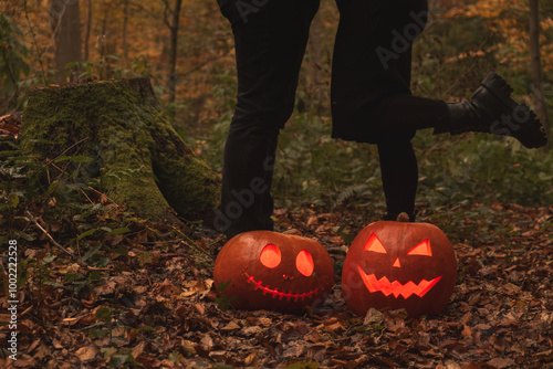 Glowing Halloween Pumpkins in Autumn Forest photo