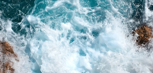 The force of a waterfall crashing into a river below, creating waves and white water