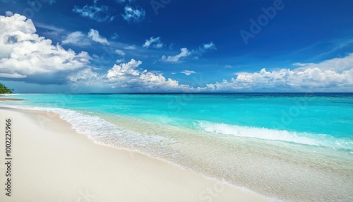 Beautiful sandy beach with white sand and rolling calm wave of turquoise ocean on Sunny day 