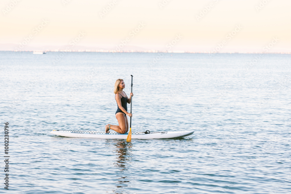 Mature woman paddleboarding on Black Sea