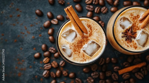 Iced coffee drinks served with cinnamon and ice cubes surrounded by coffee beans