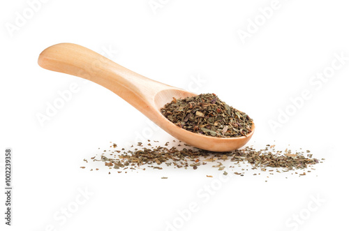 Fototapeta Naklejka Na Ścianę i Meble -  Dried basil in a wooden spoon isolated on a white background. Seasoning for cooking
