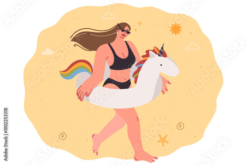 Woman with inflatable unicorn ring walks along beach, enjoying vacation on tropical island