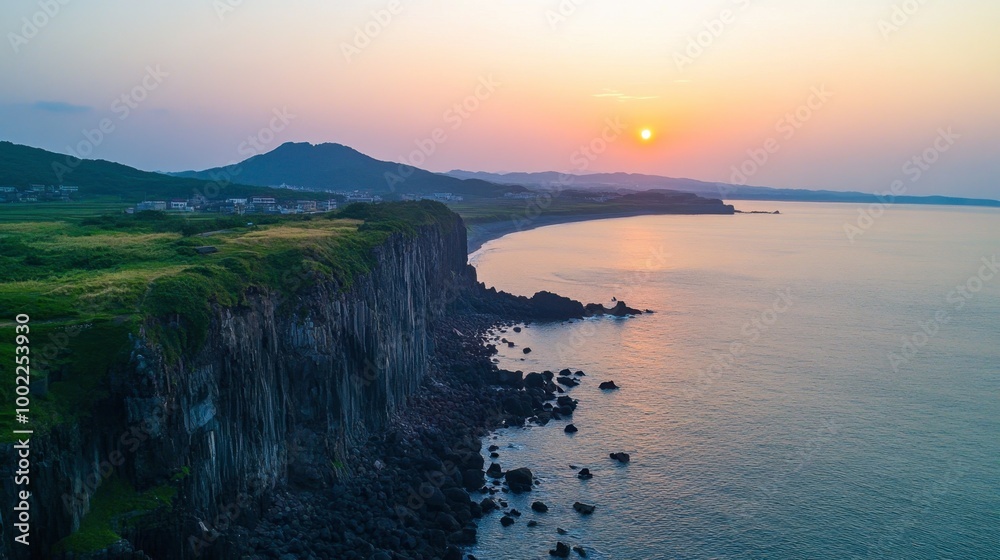 Fototapeta premium The stunning coastal view from the cliff at Seogwipo in Jeju, known for its breathtaking sunsets.