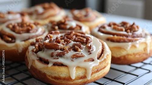 Delicious cinnamon roll topped with icing and star anise on a wooden plate