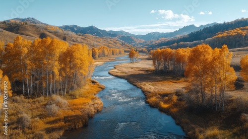 Majestic autumn landscape with a flowing river and vibrant yellow foliage nea...
