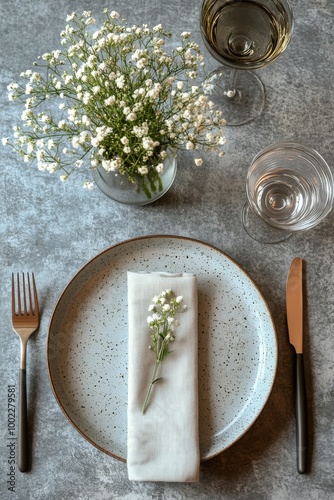 Elegant dining table set with neutral decor and glassware in a bright indoor ...